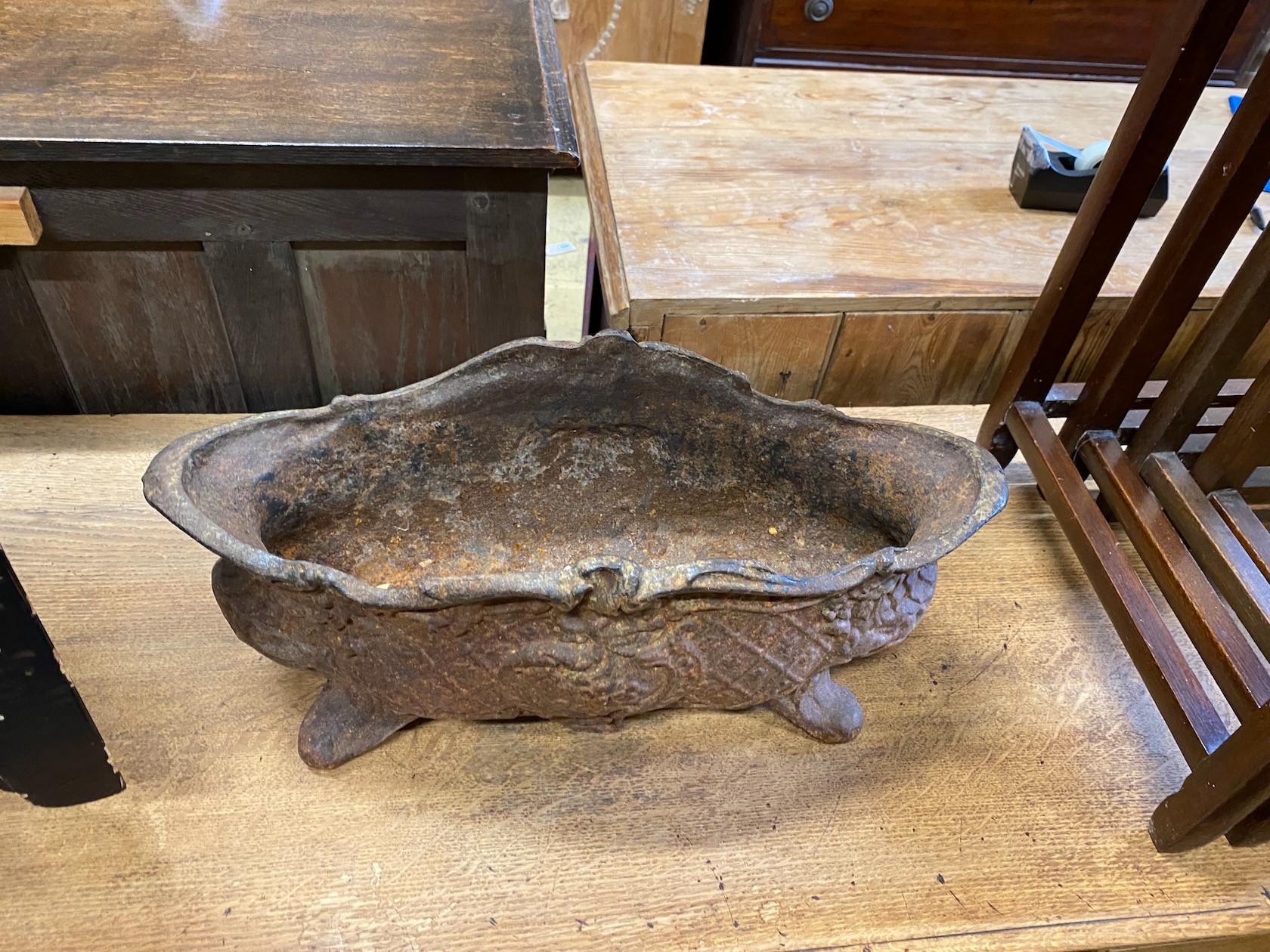 An oval cast iron garden planter, width 48cm, depth 20cm, height 21cm